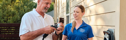Stan's employee showing a man his new EV charger