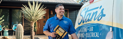 Stan's HVAC employee in front of company van