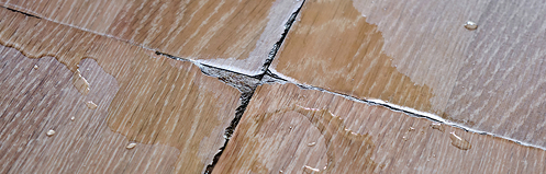 Cracks and water damage in a vinyl floor