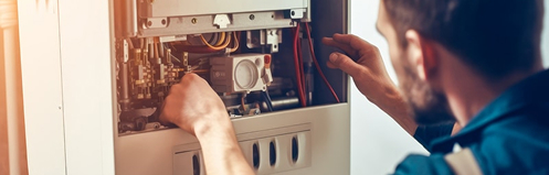 Technician repairing a furnace