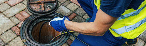 Man hydrojetting a sewer
